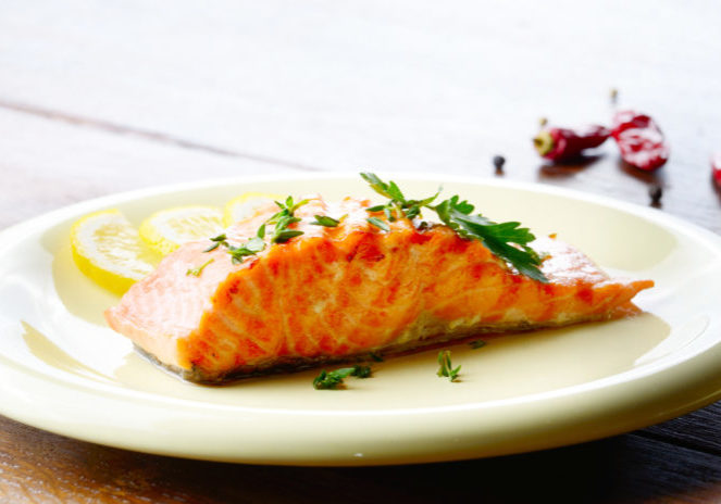 fried salmon fish filet with lemon and parsley